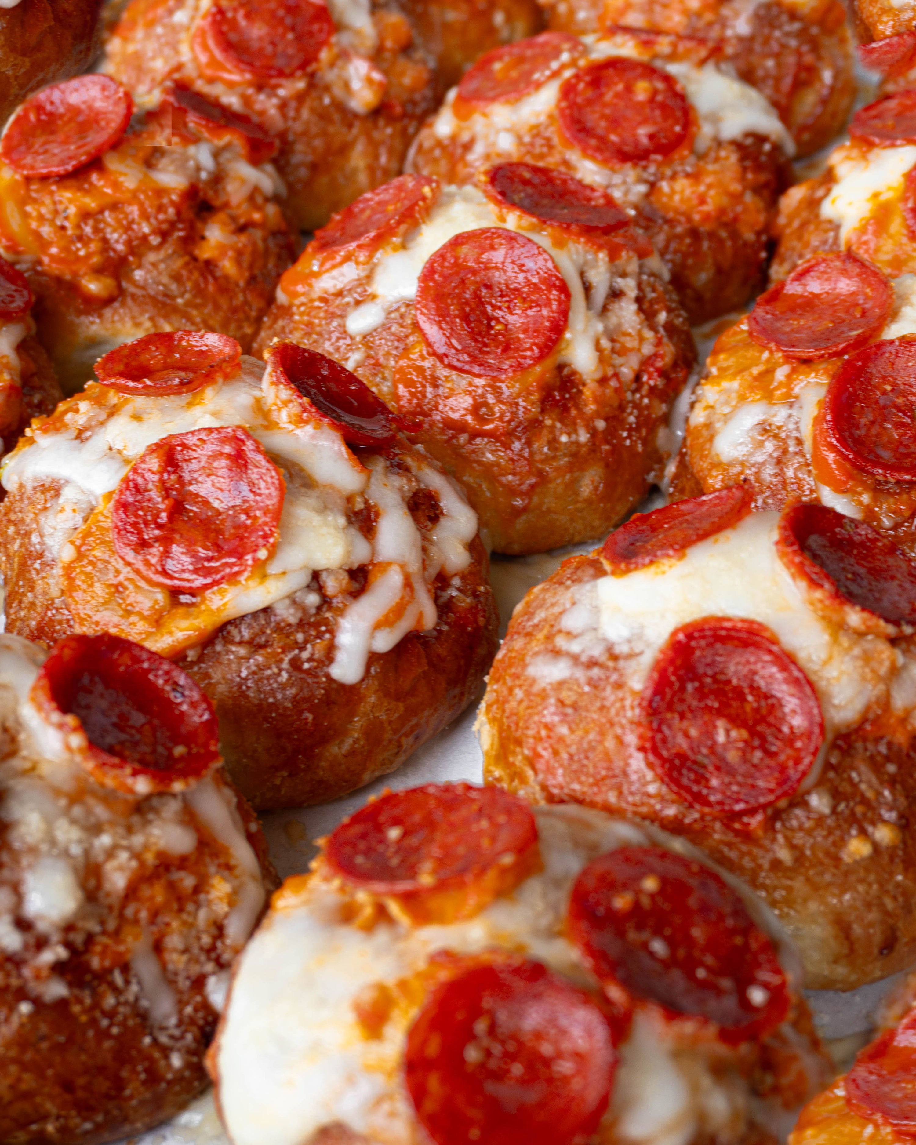 Close up of many Hot Honey Pizza Bagel Bombs 